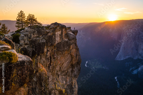 Person Standing over Taft Point, Yosemite National Park, CA photo