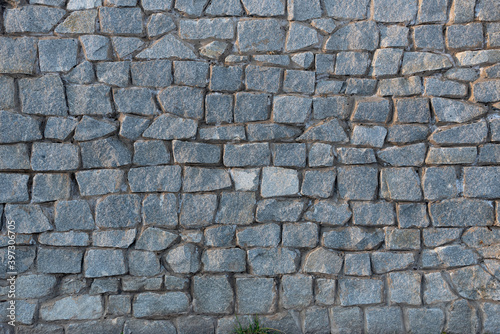 The texture of a solid stone surface created by man.