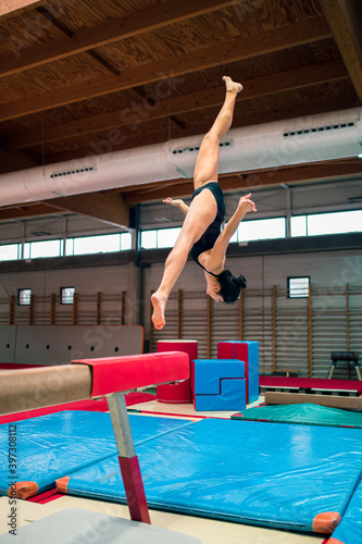 young artistic gymnast woman performing and training