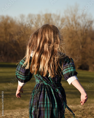 Girl Running in Woods with Sunlight Hair photo