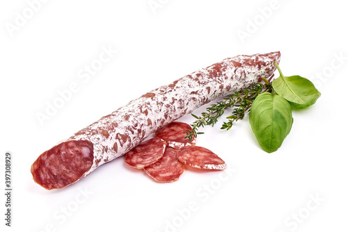 Fotografie Traditional Spanish Fuet thin dried sausage with slices, Close-up, isolated on a