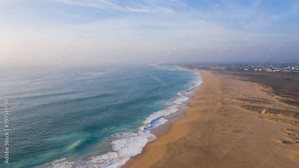 Drone views of the Cape of Trafalgar lighthouse beach on the Costa de la Luz in Caños de Meca, Cadiz Andalusia, Spain Beach from above on a beautiful day with clouds and the blue sea.