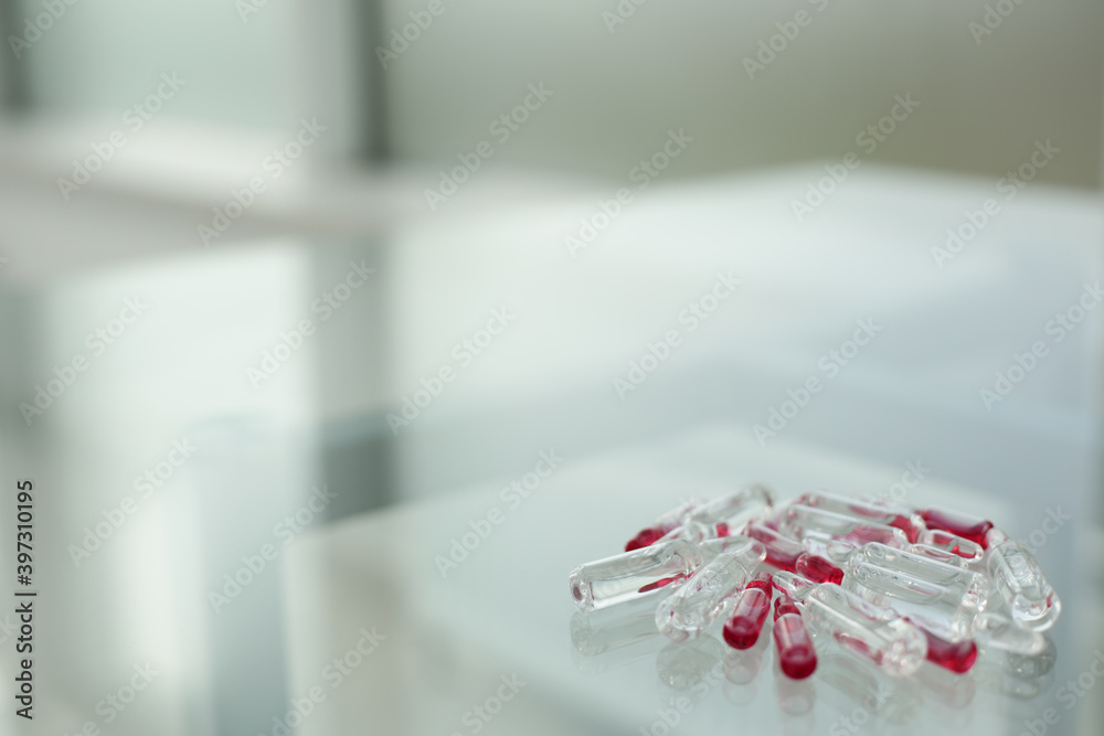 Glass ampoules on a glass table Glass ampoules on a glass table