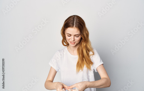 Cheerful pretty woman in a white t-shirt with packages in her hands shopping lifestyle