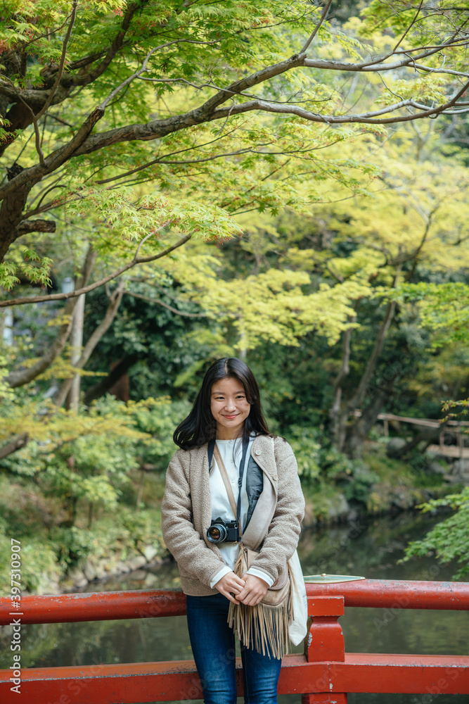 Portraito of a Woman in Japanese Traditional Garden with Beautiful Fresh Green Portraito of a Woman in Japanese Traditional Garden with Beautiful Fresh Green