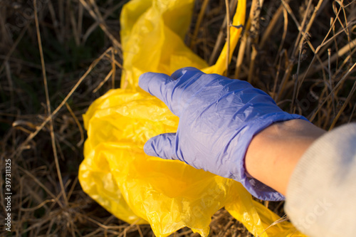 Anonymous gloved hand pick up a packet