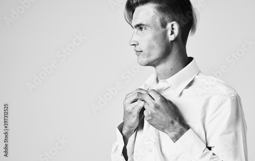 portrait of a young man in a shirt on a light background Gentleman suit