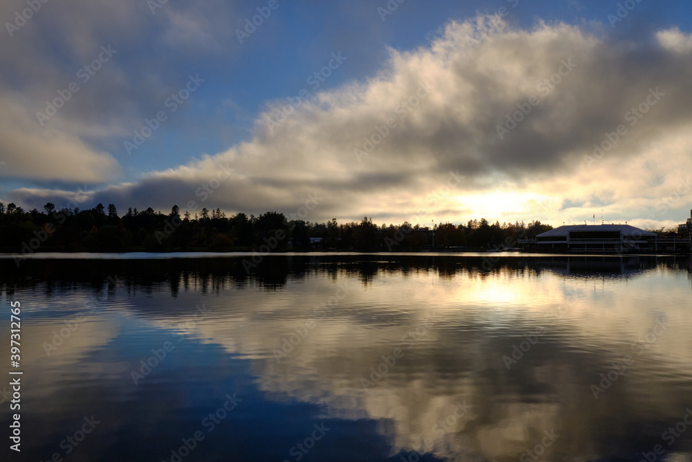Dow's Lake in Ottawa at sunset with large triangle cloud reflection in flat surface