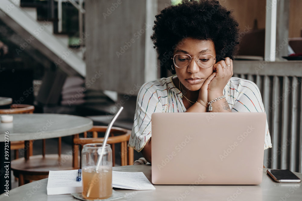 Focused black girl studying using online continuing education courses Focused black girl studying using online continuing education courses