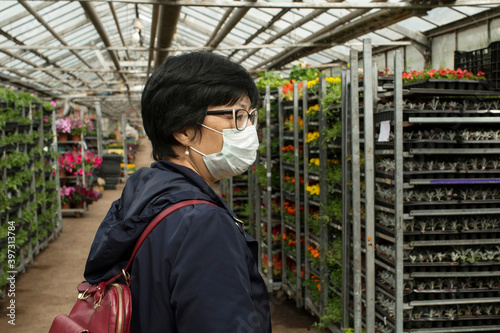 Asian woman in a greenhouse photo