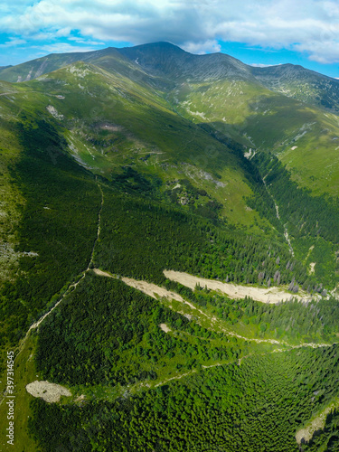 Aerial drone view above the highlands of Parang Mountains. Parangul Mare peak guards Gilort River valley and the surroundings. Summer, Carpathia, Romania photo