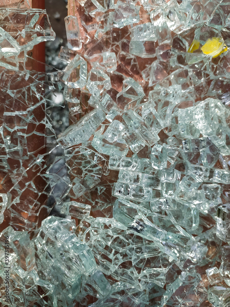 Broken window glass. Small transparent fragments on the surface of the bench. Background, texture