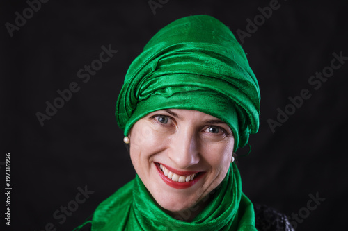 Beautiful muslim woman dressed in green headscarf photo