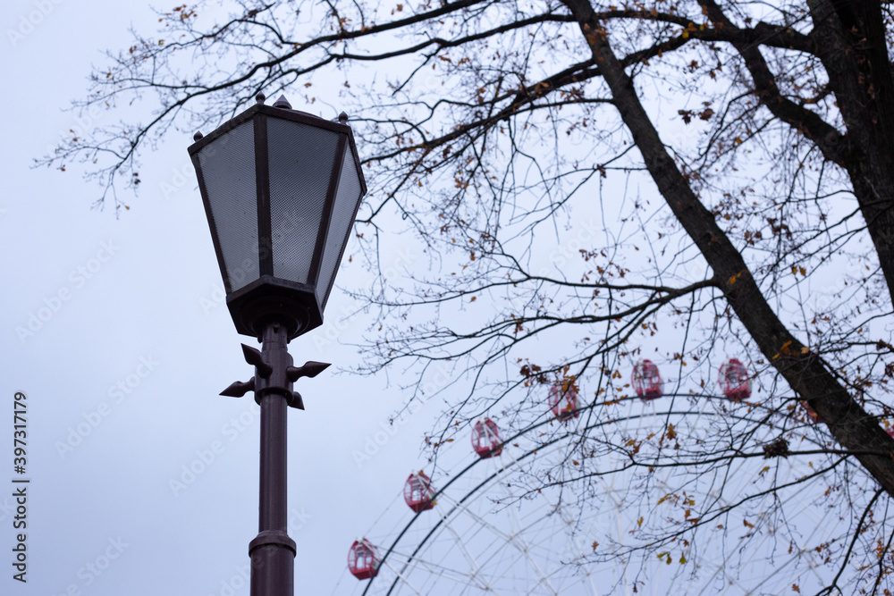 Street lamp on the background of the Ferris wheel Street lamp on the background of the Ferris wheel