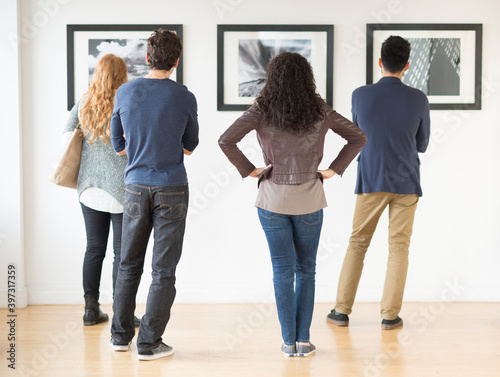 Couples admiring art in gallery