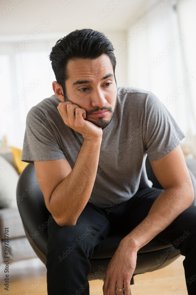 Mixed race man resting chin in hand Mixed race man resting chin in hand