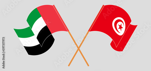 Crossed and waving flags of the United Arab Emirates and Tunisia