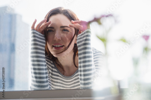 Woman peering in through window