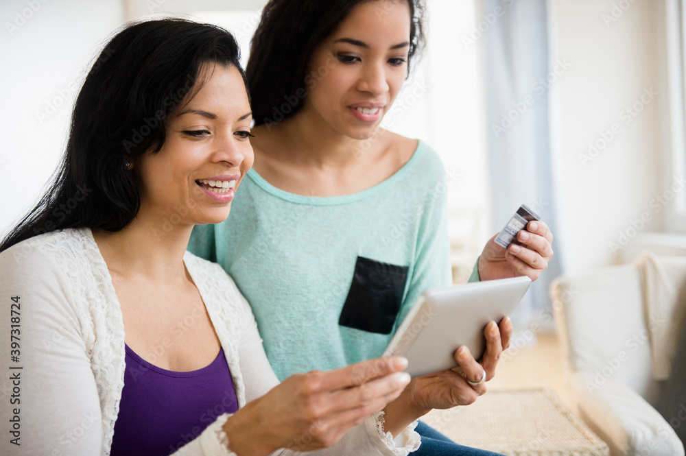 Mother and daughter using tablet computer together Mother and daughter using tablet computer together
