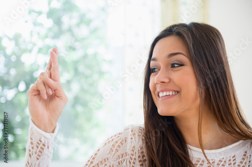 Woman crossing her fingers photo