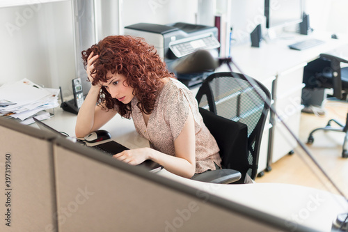 Hispanic businesswoman working in office photo