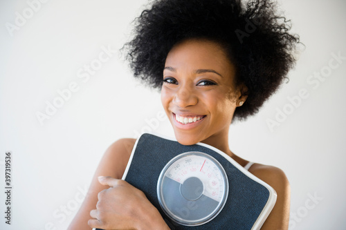 African American woman holding scale photo