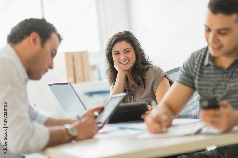 Hispanic business people working in office Hispanic business people working in office