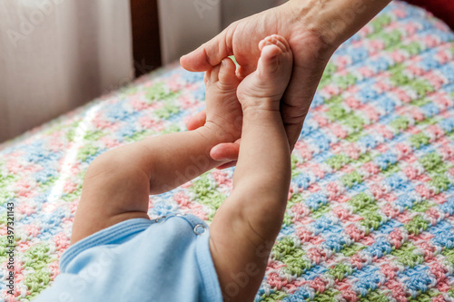 Mother holding feet of baby boy