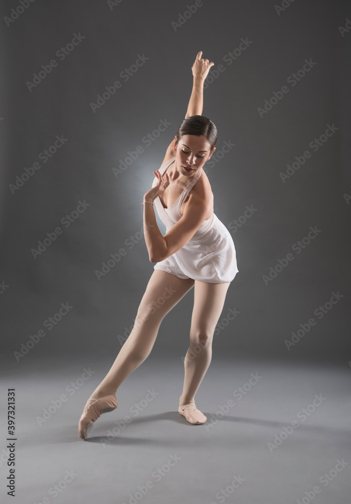 Hispanic ballet dancer posing on tip toe Hispanic ballet dancer posing on tip toe