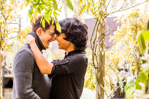 Smiling couple rubbing noses in park