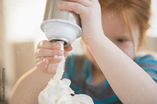 Caucasian girl spraying whipped cream