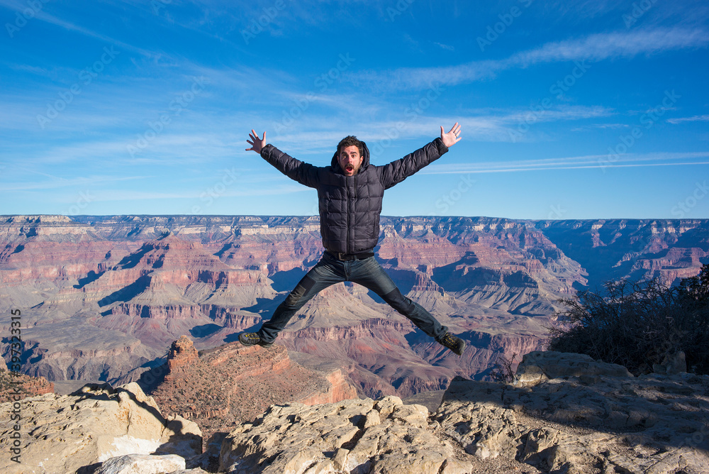 Caucasian man jumping at Grand Canyon, Arizona, United States Caucasian man jumping at Grand Canyon, Arizona, United States