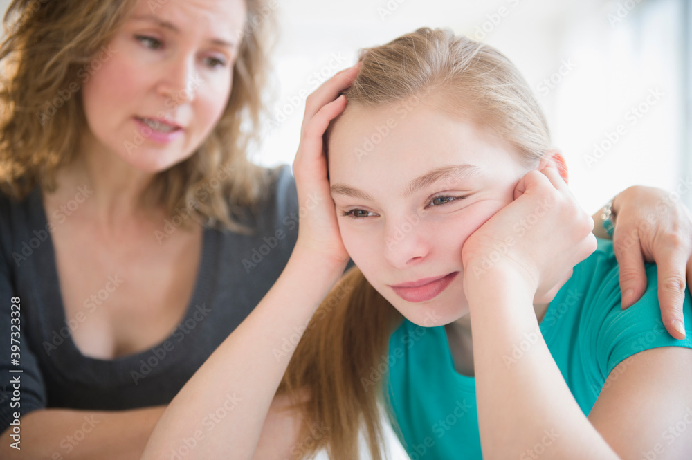 Caucasian mother comforting crying daughter Caucasian mother comforting crying daughter