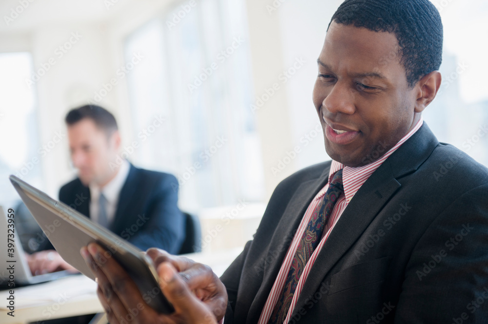 Businessman using digital tablet in office Businessman using digital tablet in office