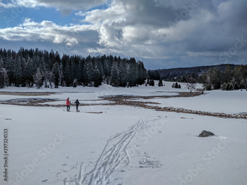 cross country skiing couple in the winter national park woods photo