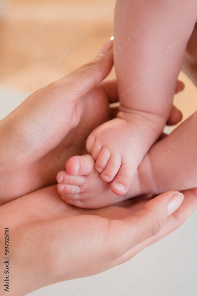 Close up of mother holding bare feet of baby Close up of mother holding bare feet of baby