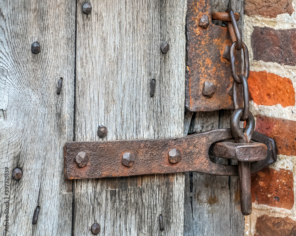 Historic Ancient rusty lock on gate with bricks Historic Ancient rusty lock on gate with bricks
