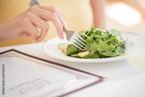 Hispanic woman eating salad