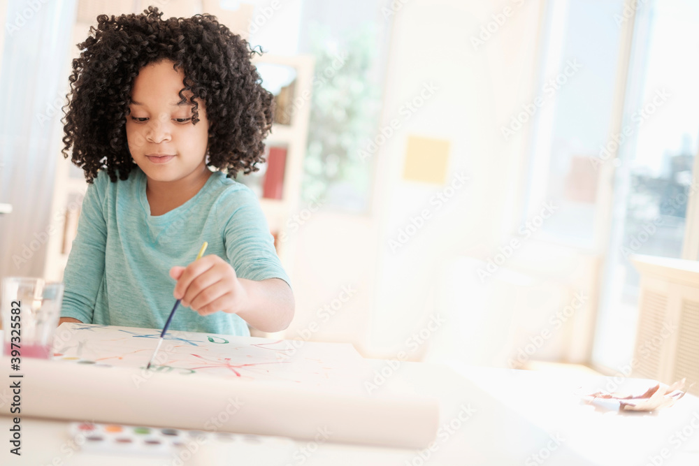 African American girl painting with watercolors African American girl painting with watercolors