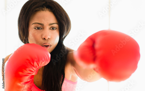 Mixed race boxer punching photo