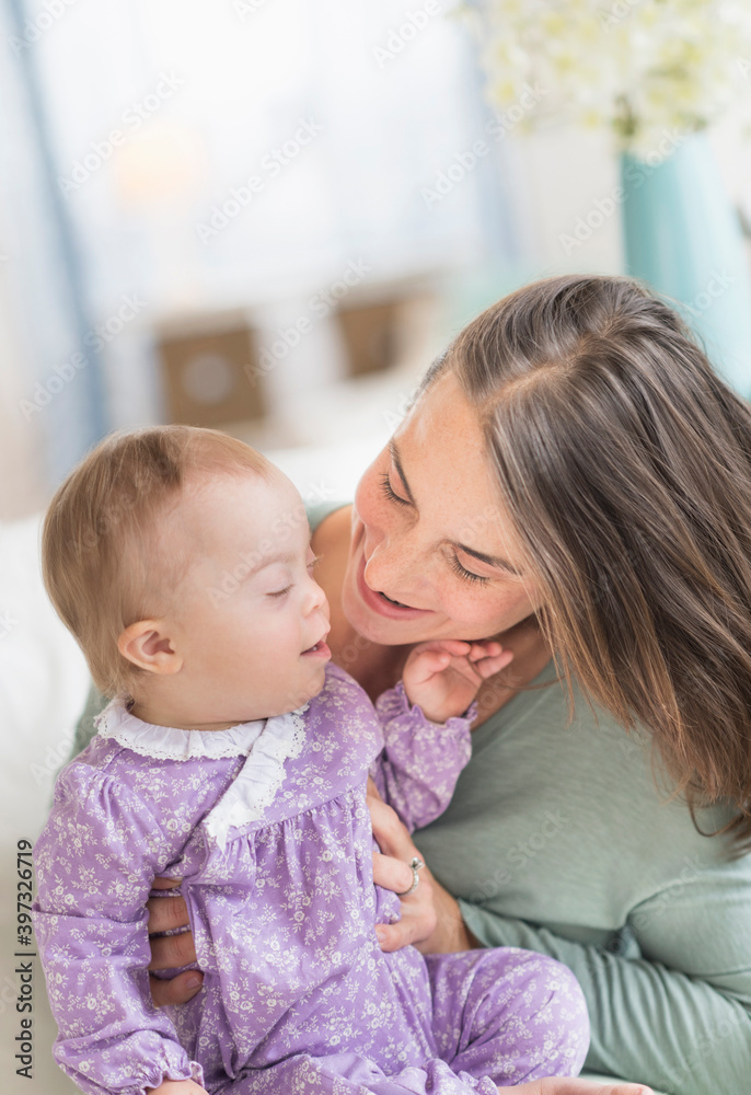 Caucasian mother playing with baby with Down Syndrome Caucasian mother playing with baby with Down Syndrome