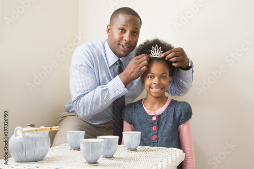 African father and daughter posing with tiara