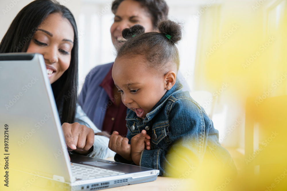 Black multi-generation family using laptop Black multi-generation family using laptop
