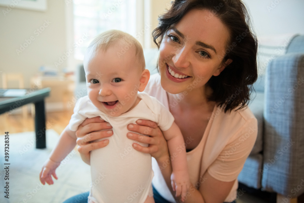 Proud Caucasian mother posing with baby son Proud Caucasian mother posing with baby son