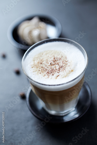 Coffee with milk on dark stone background. Close up. 