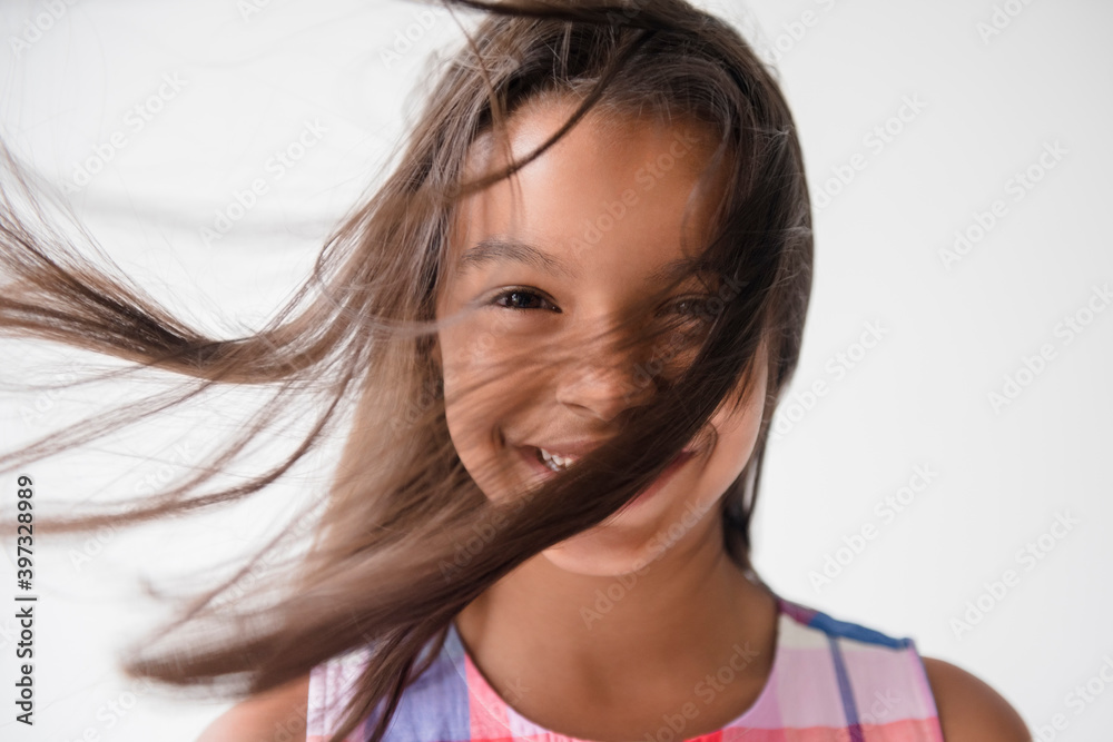 Wind blowing hair of smiling Mixed Race girl Wind blowing hair of smiling Mixed Race girl