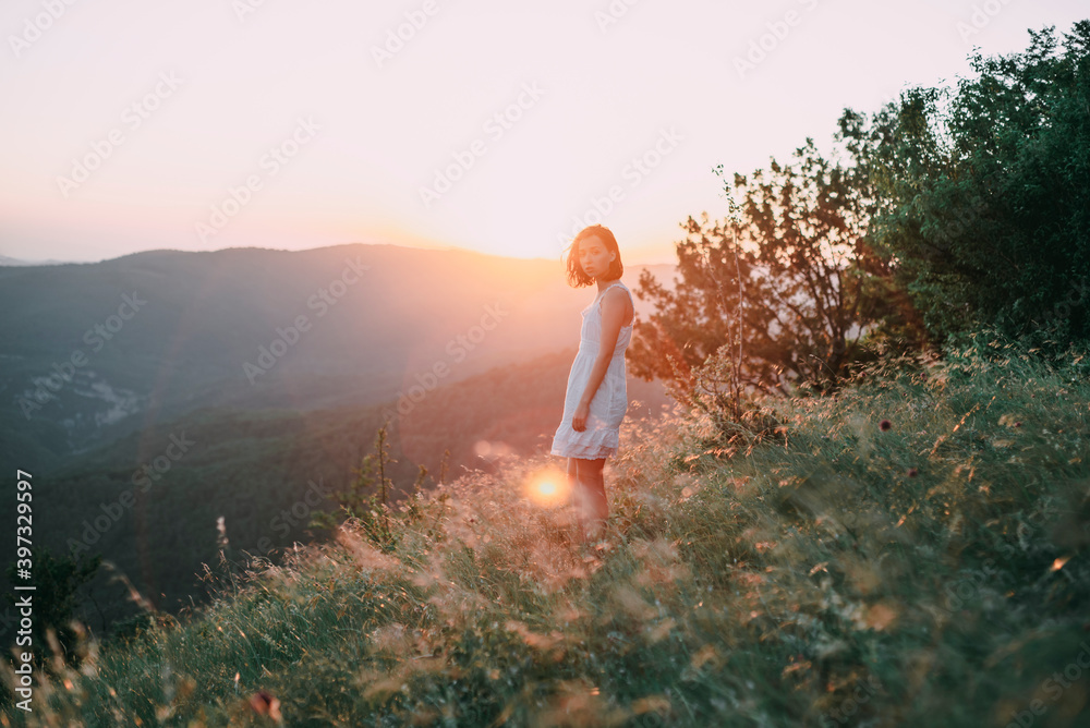 Serious Caucasian woman standing on mountain Serious Caucasian woman standing on mountain
