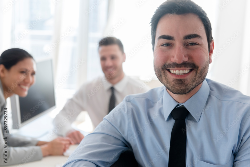 Portrait of smiling businessman in office Portrait of smiling businessman in office