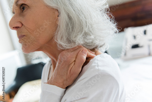 Older woman rubbing the neck