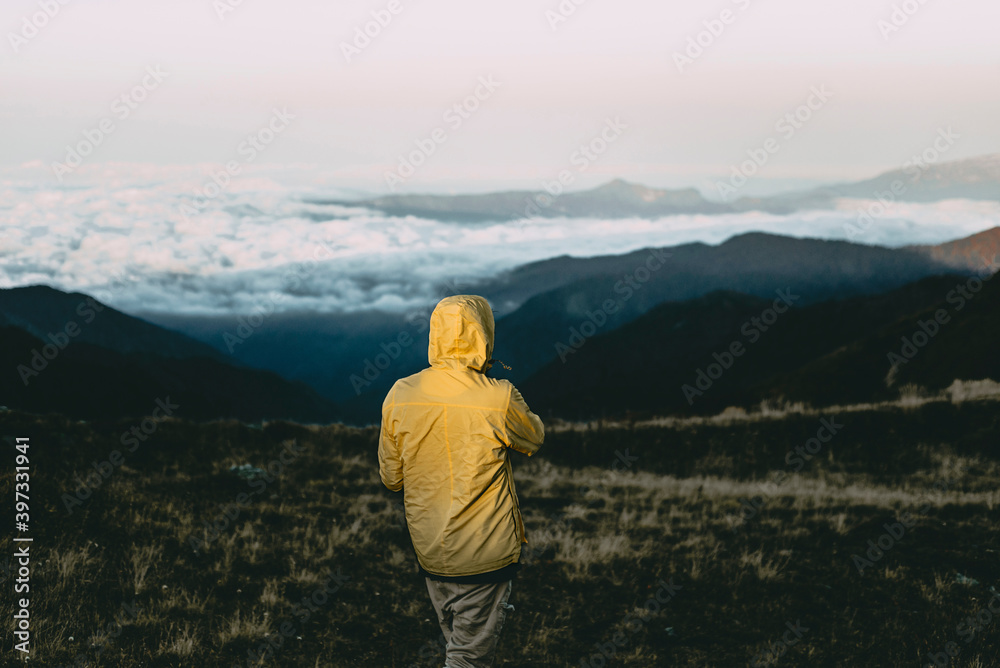 Caucasian man standing in remote mountain landscape Caucasian man standing in remote mountain landscape
